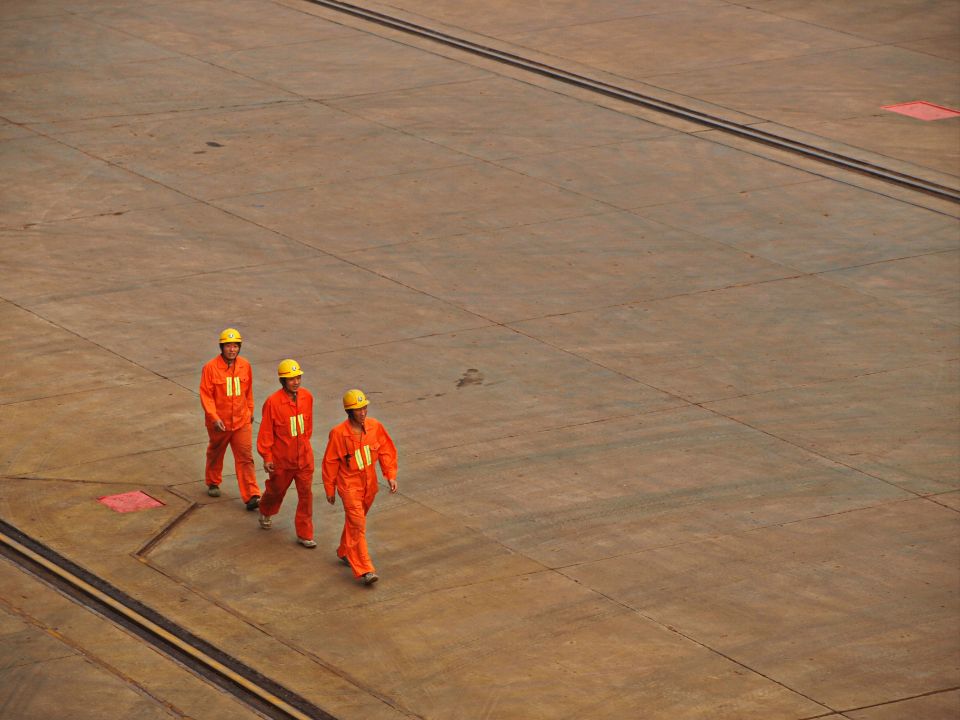 Workers in hi-vis and helmets